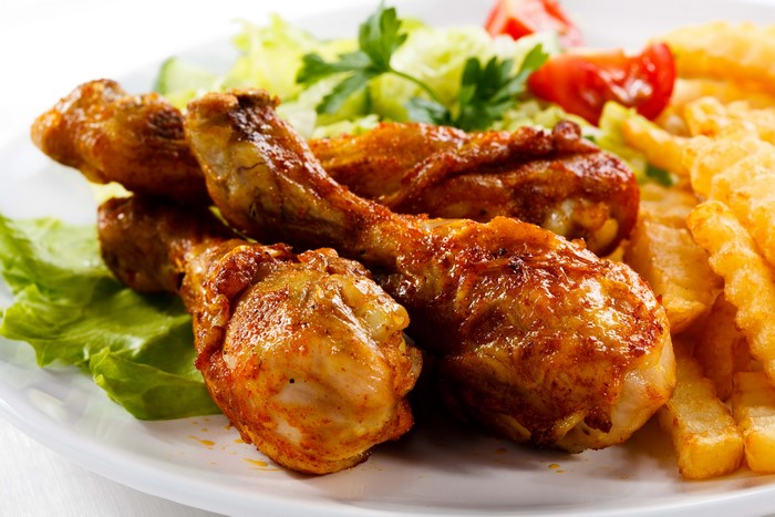 Delicious Grilled Chicken Drumsticks with Fries and Salad