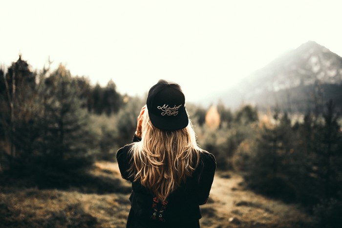 Blonde Girl Wearing Cap in Forest at Dusk