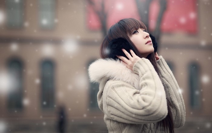 Asian Girl Wearing Cozy Jacket Enjoying Snowfall