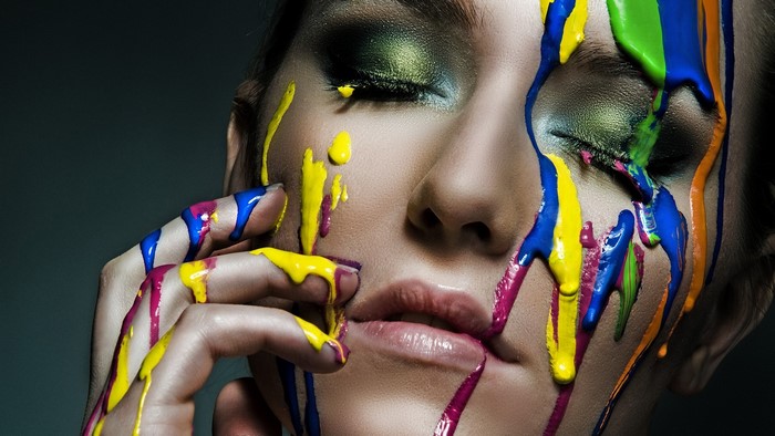 Creative Woman's Face with Dripping Colorful Paint