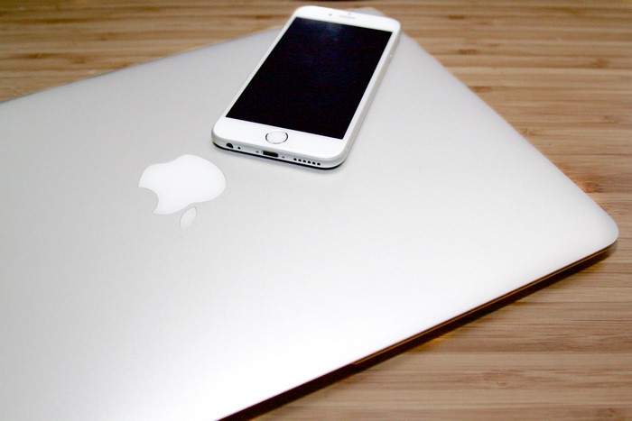 Apple Macbook and iPhone on a wooden surface
