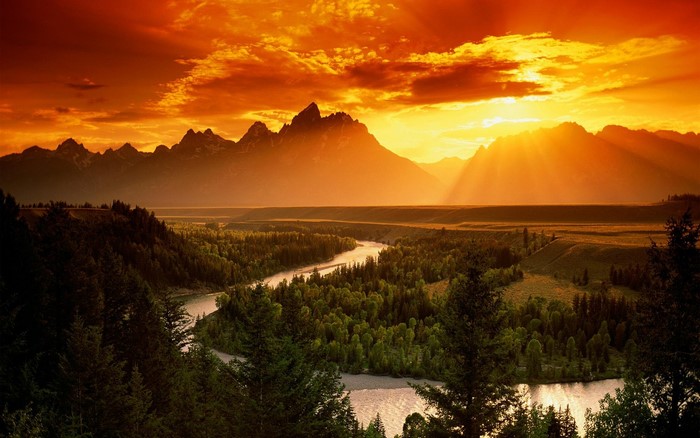 Sunset over mountains and winding river