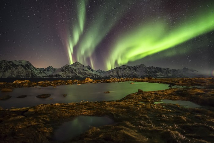 Northern Lights over Mountains and Lake in Norway