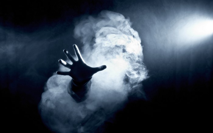 Hand reaching out of smoke