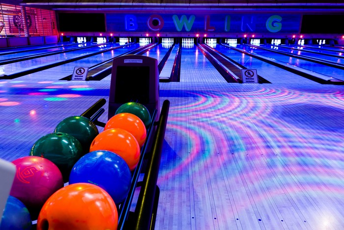 Bowling alley with colorful balls and lanes