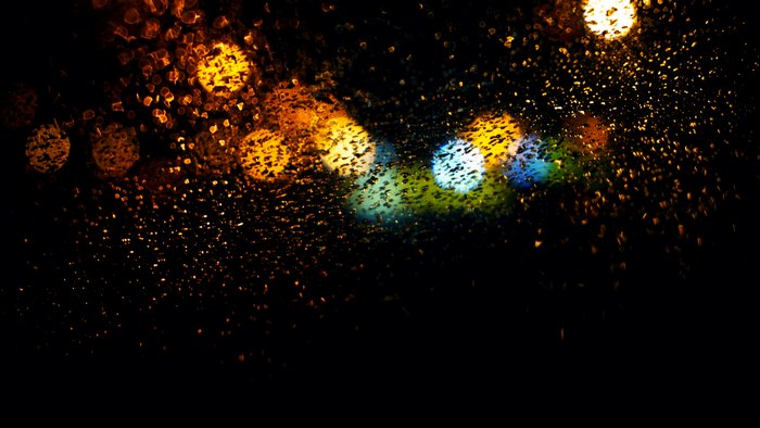 Bokeh effect with rain on glass at night