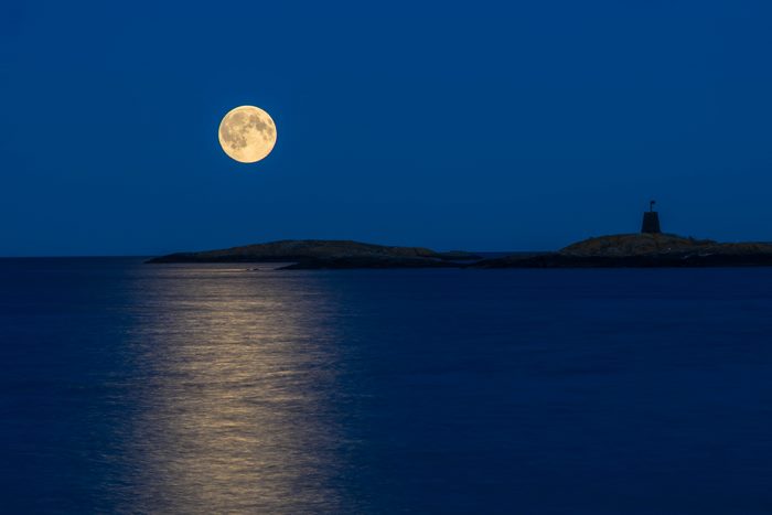 Full moon over the sea with island and lighthouse