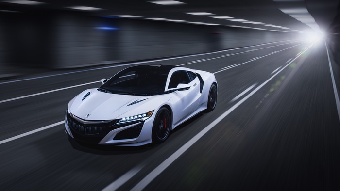 White Acura NSX driving through a tunnel