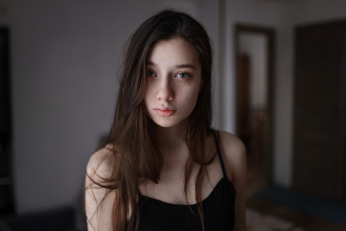 Woman with freckles and long black hair