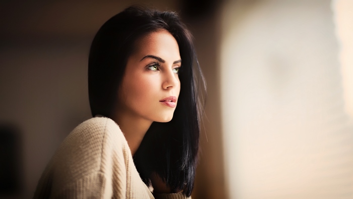 Woman with black hair and green eyes