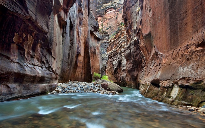River flowing through a narrow canyon with towering rock walls