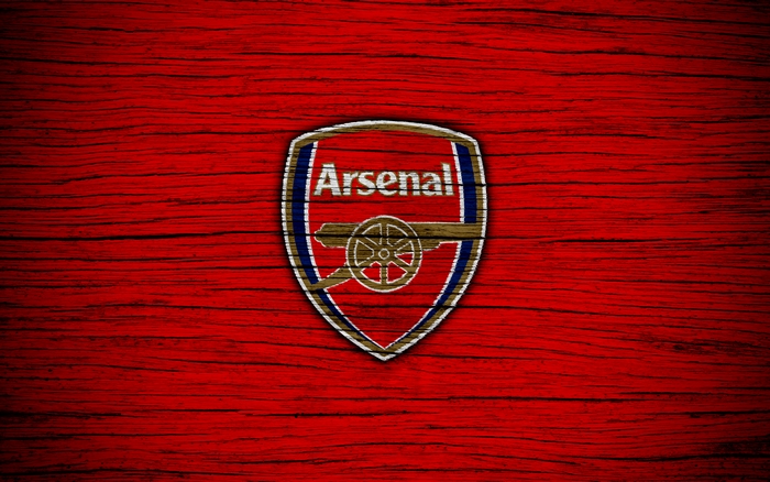 Arsenal F.C. logo on red wooden background