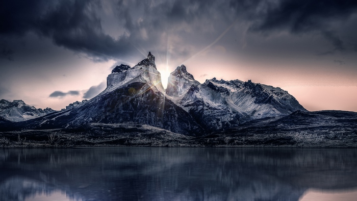 Sunrise over majestic mountains reflected in a lake