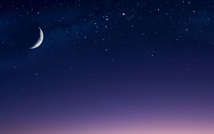 Crescent moon and stars in the night sky
