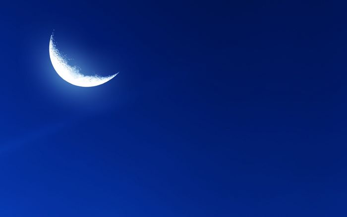 Crescent moon in a dark blue sky
