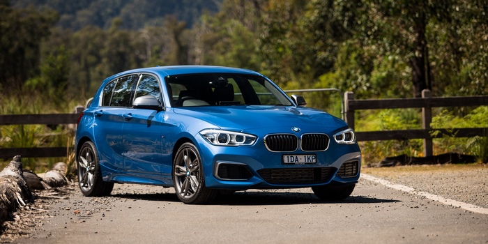 Blue BMW 1 Series Car on a Road