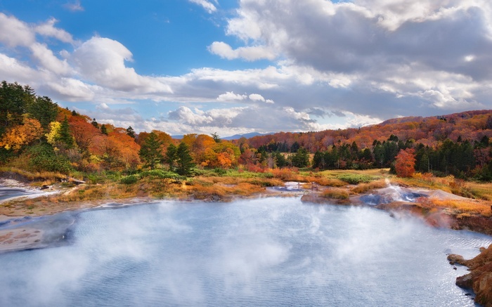 Steaming Blue Pond Surrounded by Autumn Foliage