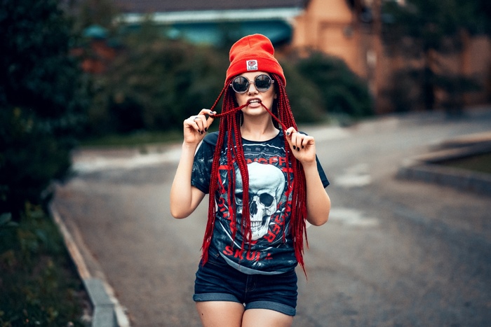 Woman with red dreadlocks and skull t-shirt