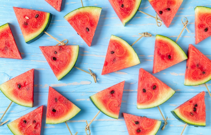 Slices of watermelon on a blue wooden background