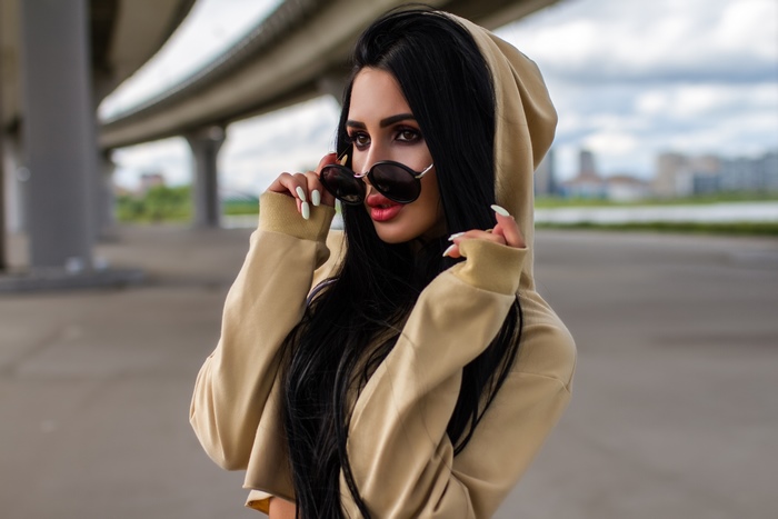 Woman in sunglasses and hood