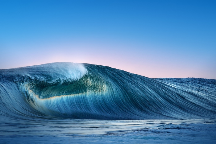 Ocean wave breaking at sunrise