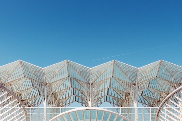 Modern Glass Roof Architecture Against Blue Sky
