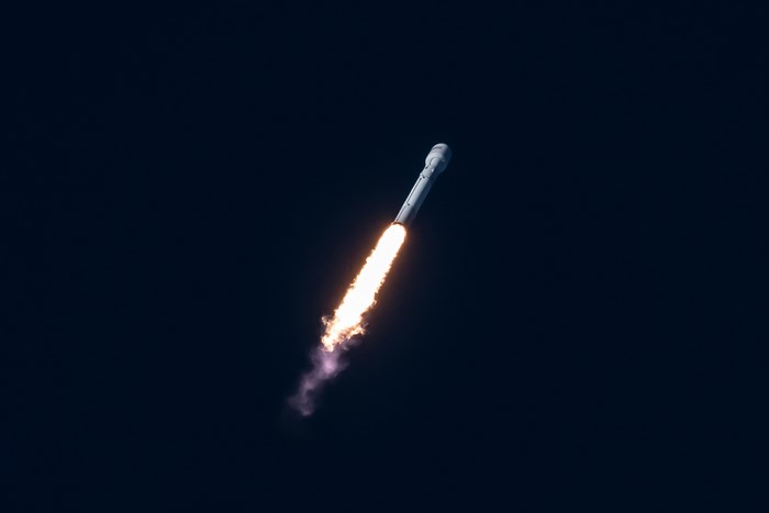SpaceX rocket launching with bright flames