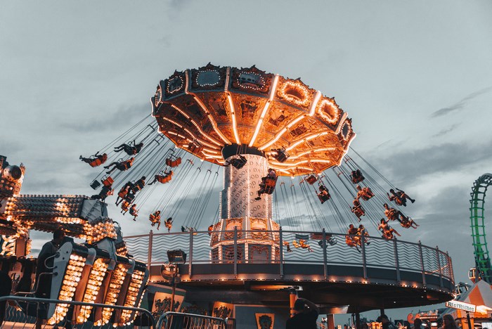 Amusement park swing ride at sunset