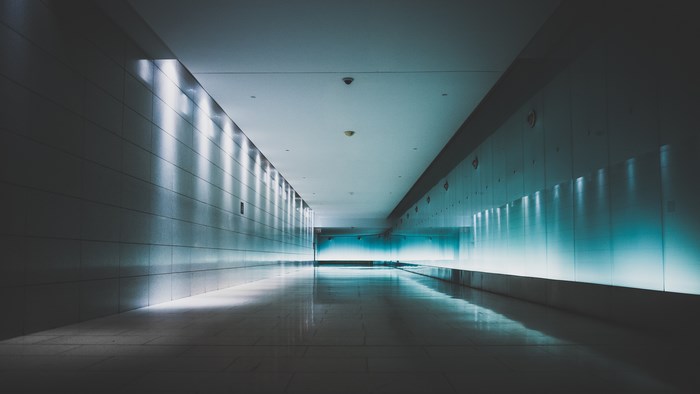 Modern illuminated interior passageway with blue lighting