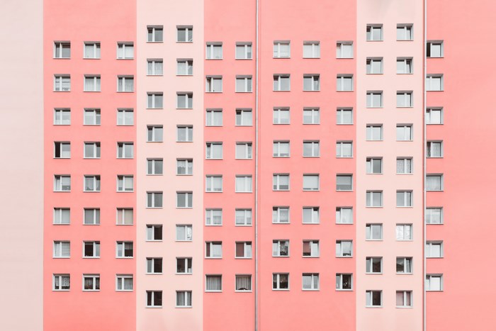 Pink and Lilac Apartment Building Facade with Windows