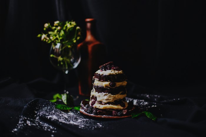 Chocolate cake with cream and blackberries