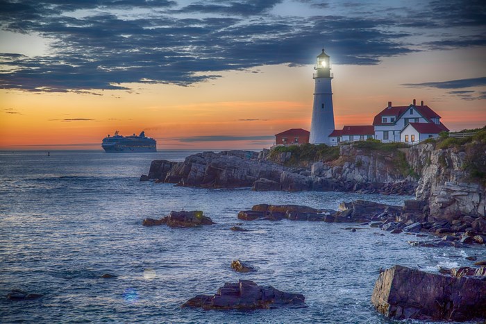 Lighthouse and Cruise Ship at Dusk on Rocky Coast