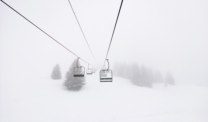 Ski lift in a foggy winter landscape