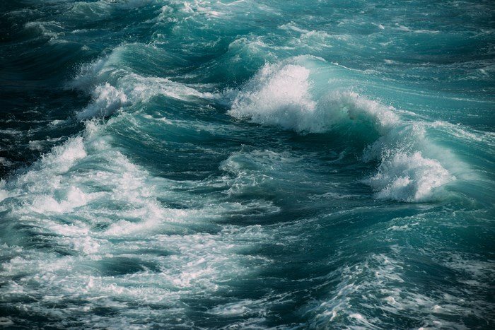 Rough ocean waves with white foam