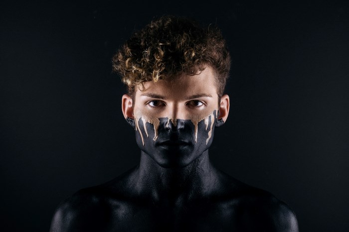 Man with black and gold face paint