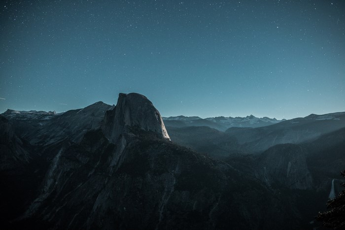Half Dome mountain under starry night sky