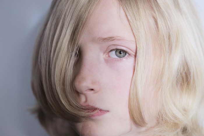 Close-up portrait of a young blonde child