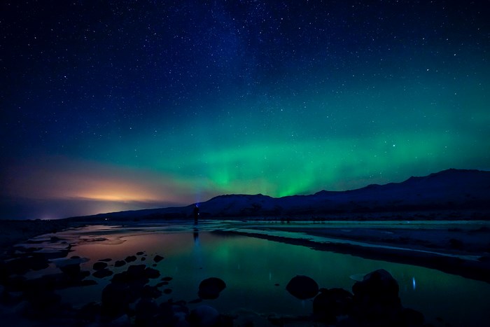 Northern Lights Over Icy Mountain at Night