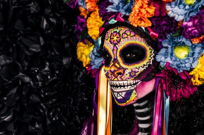 Woman with Day of the Dead face paint and floral headdress