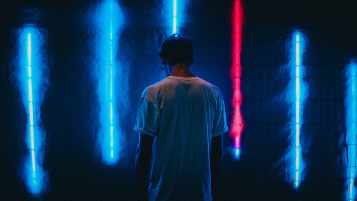 Man standing in front of neon lights