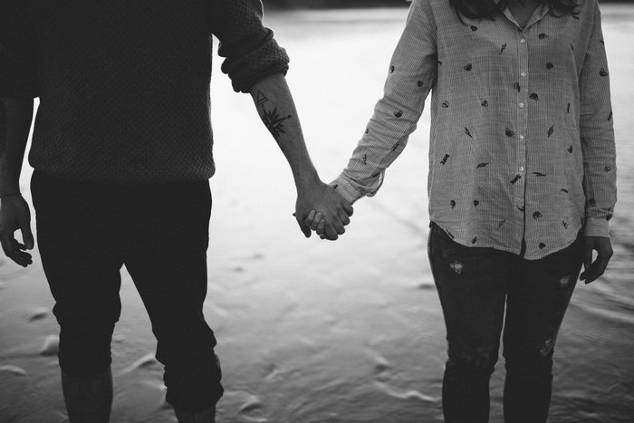 Couple holding hands on a beach