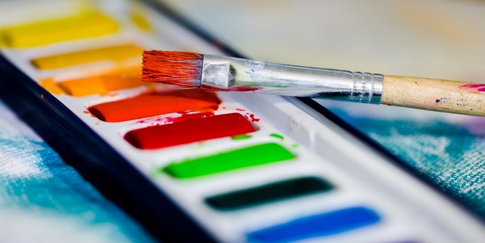 Watercolor paint palette with a paintbrush