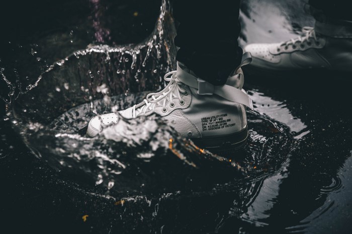 White Nike SF AF1 Mid sneakers splashing in water