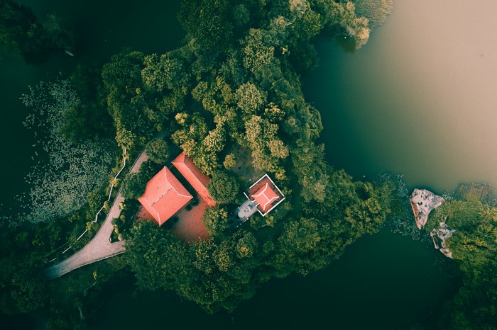 Aerial view of buildings and trees by a lake in Vietnam
