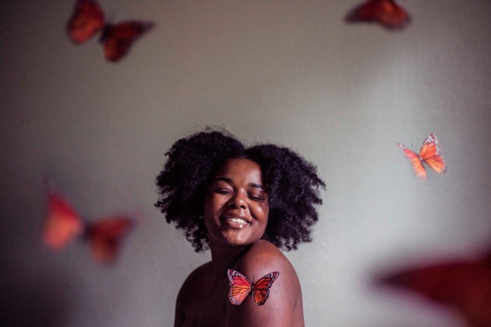 Woman with afro and butterflies