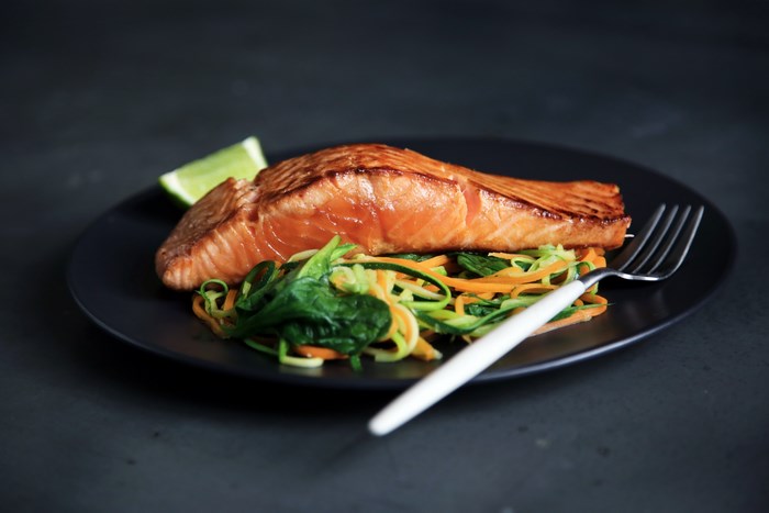 Grilled Salmon with Lime and Vegetables on Black Plate