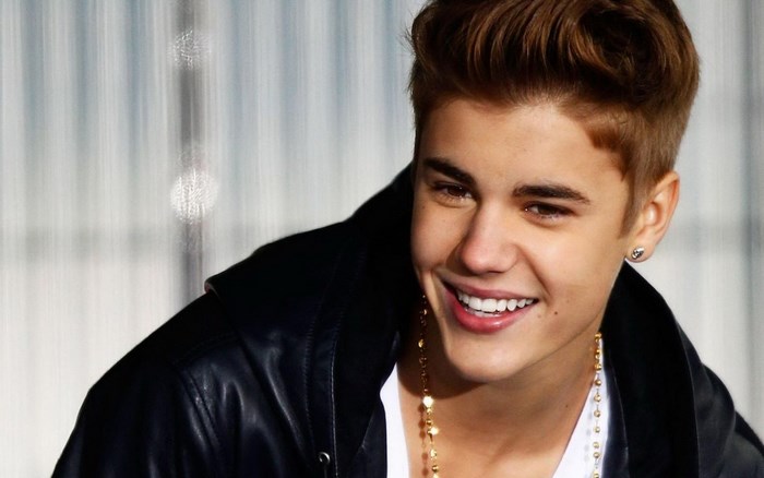 Justin Bieber wearing a black jacket and gold necklace