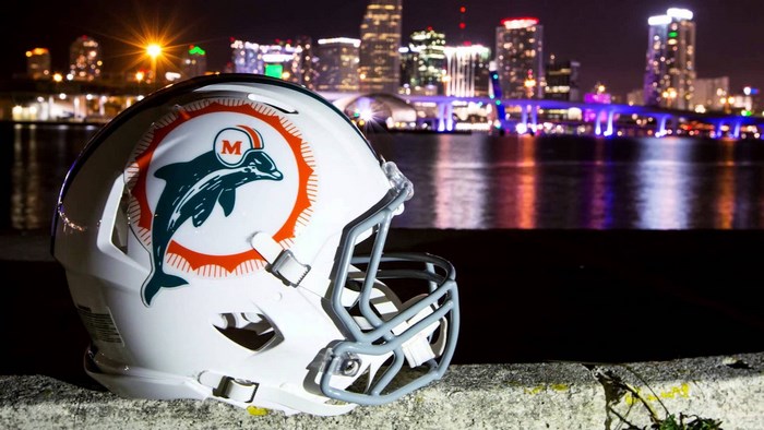 Miami Dolphins helmet with city skyline at night