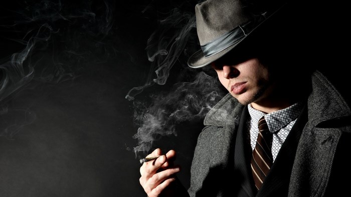 Man in fedora smoking a cigarette