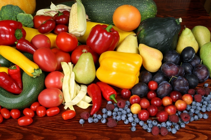 Assortment of fresh fruits and vegetables on a wooden table